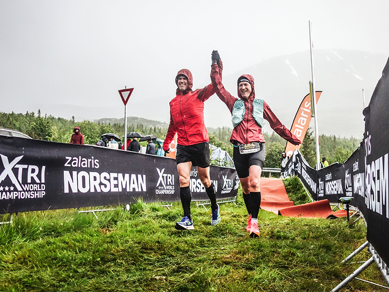 Endurance athletes celebrating together at the Norseman finish